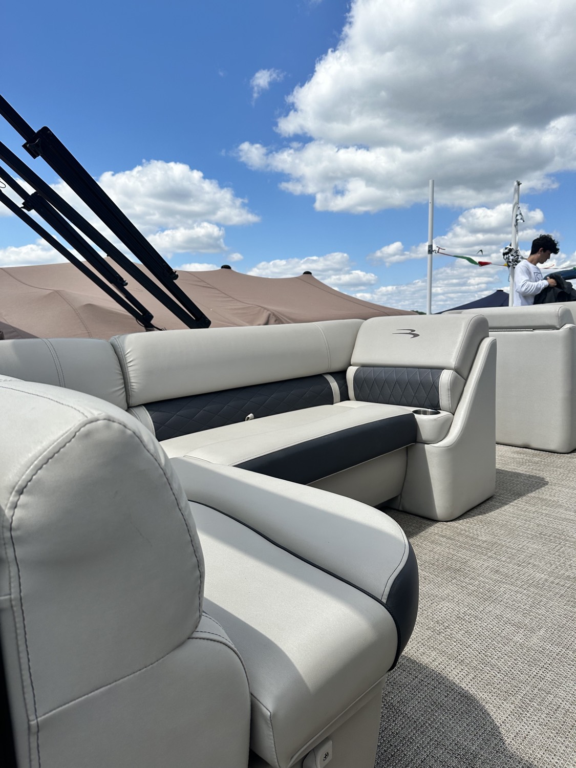 AL Luxury co-owner detailing a pontoon boat on the lake