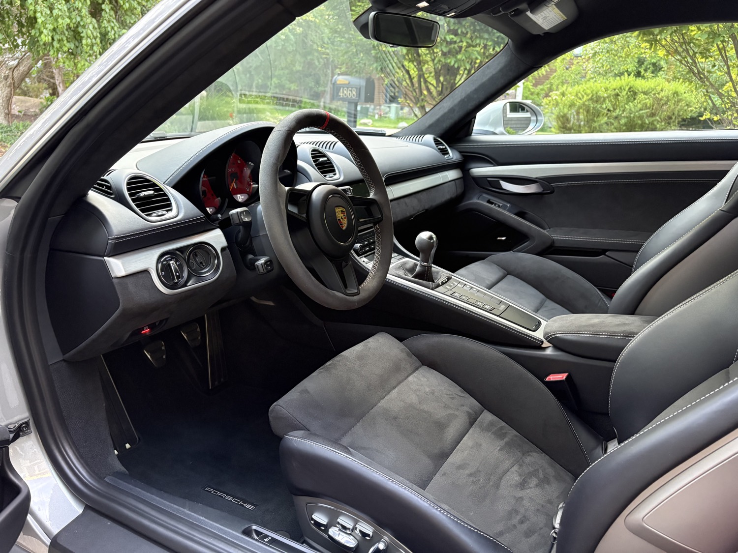 Detailed Porsche GT4 interior with clean Alcantara surfaces